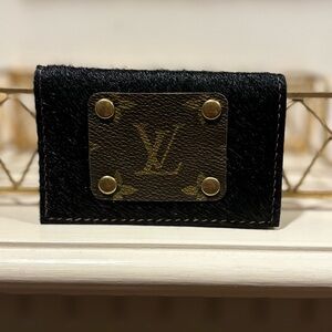 Repurposed LV car holder in a black cow hide